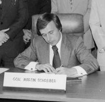 Governor Martin Schreiber signing bill at desk